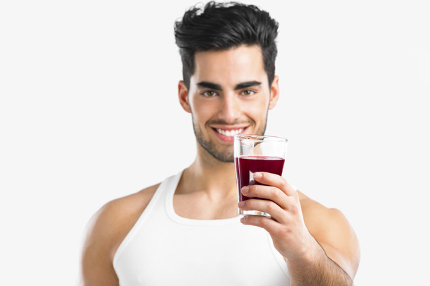 Athletic man drinking a juice - Foto, imagen