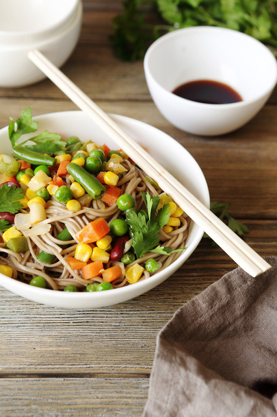 Noodles with vegetables in a white bowl - Photo, image