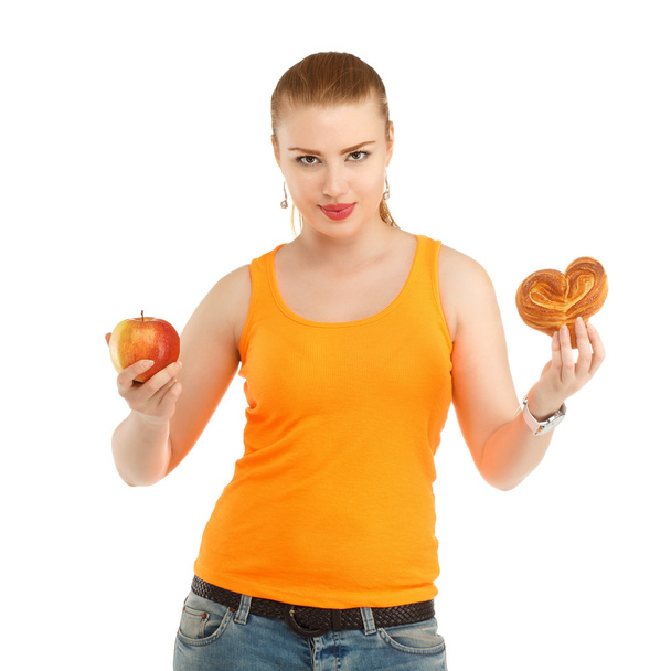 Молода красива дівчина думає, що їсти, щоб схуднути
 - Фото, зображення