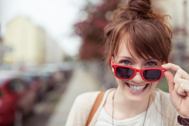 Pretty vivacious woman in trendy red sunglasses - Photo, Image