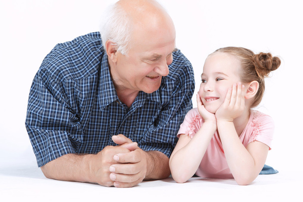 Grandfather having fun with his granddaughter - Photo, image