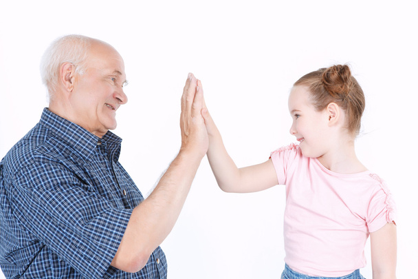 Grandfather having fun with his granddaughter - Foto, afbeelding