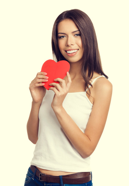 Young woman showing red heart shape symbol - Valokuva, kuva