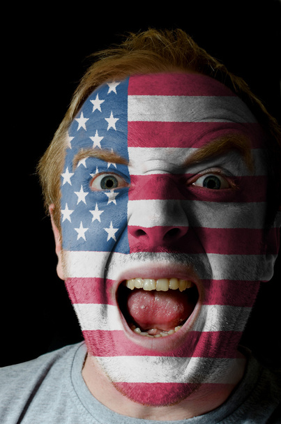 Face of crazy angry man painted in colors of american flag - Foto, imagen