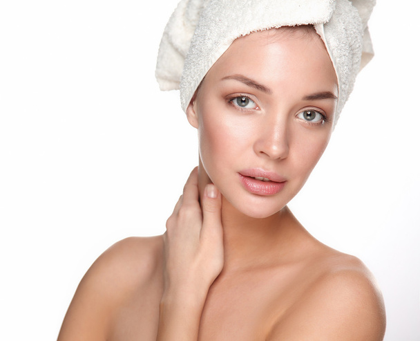 Portrait of beautiful girl touching her face with a towel on  head - Foto, Imagen