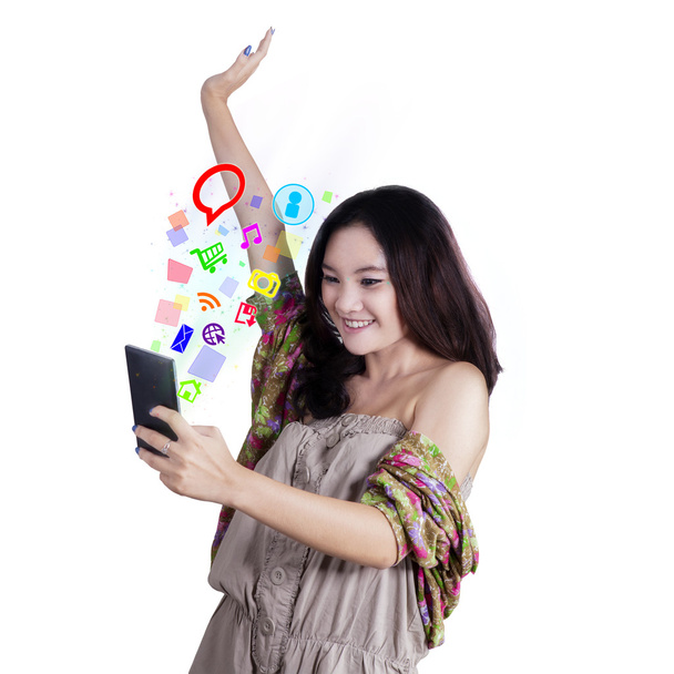 Cheerful girl browsing internet on cellphone - Fotó, kép
