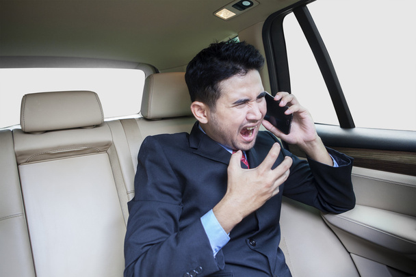 Male entrepreneur scold someone on the phone - 写真・画像