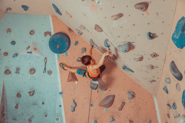 Boy wearing in safety equipment climbing indoor - Foto, Bild