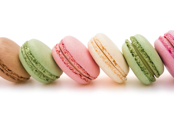Colorful macaroons line up on white with clipping path - Photo, image