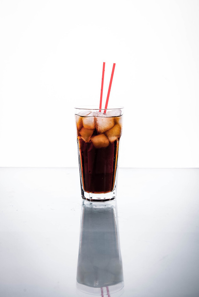 Cola in a glass with ice with red tube. soft drinks - Fotografie, Obrázek