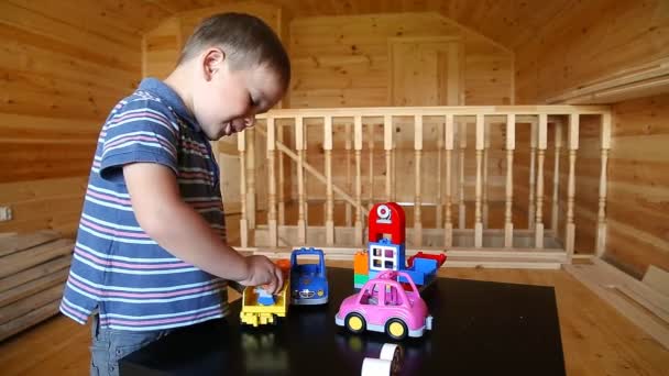 Cute boy plaing with toy car - Footage, Video