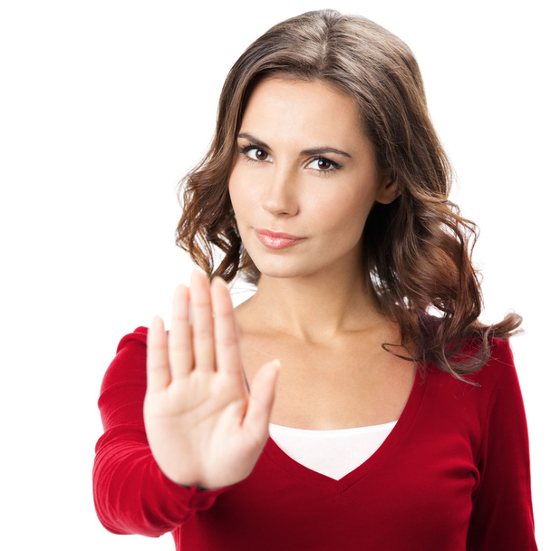 Mujer seria con gesto de stop, sobre blanco
 - Foto, imagen