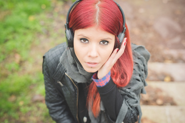 young beautiful red hair venezuelan woman lifestyle listening mu - Photo, Image