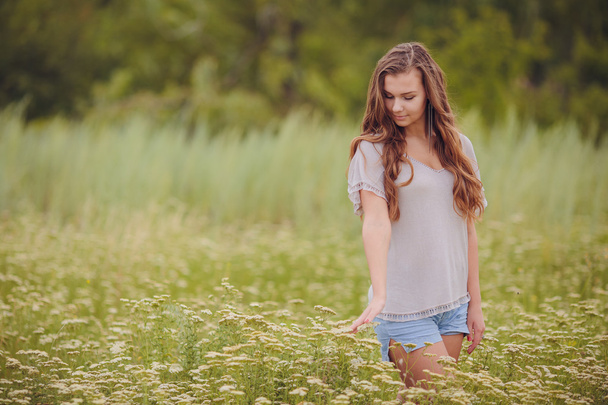 Candid skipping carefree adorable woman in field  - Photo, image