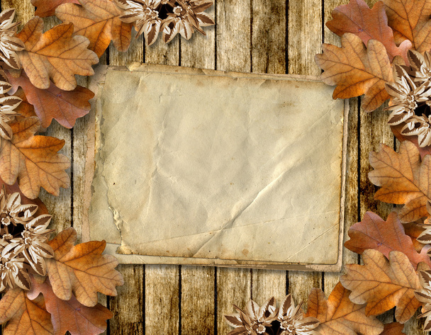 Autumn frame of oak leaves on a grange wooden background. - Photo, image