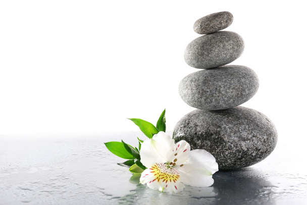 Stack of spa stones with flower isolated on white - Photo, Image