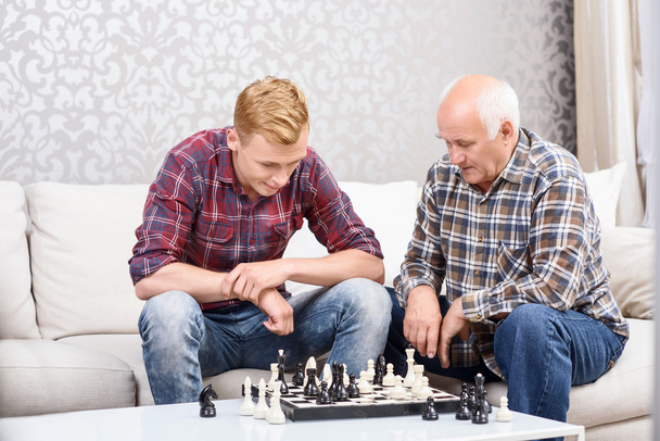 Grandfather and grandson playing chess  - Zdjęcie, obraz