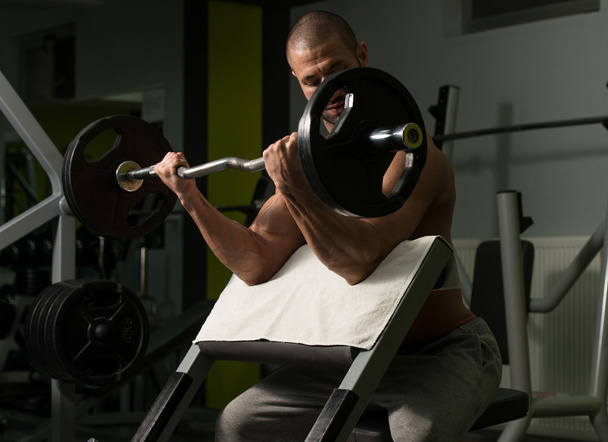 Bodybuilder Exercising Biceps With Barbell - Fotoğraf, Görsel