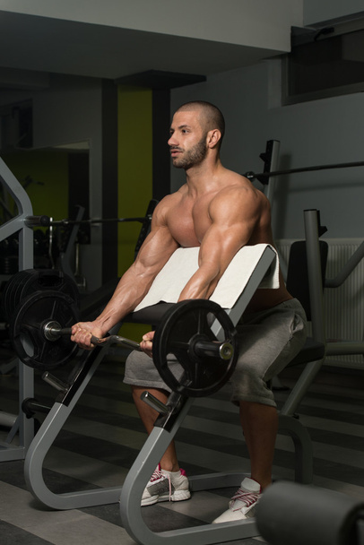 Young Man Doing Exercise For Biceps - Foto, Bild