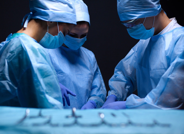 Team surgeon at work in operating room. - 写真・画像