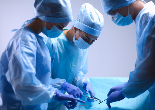 Team surgeon at work in operating room. - Foto, afbeelding