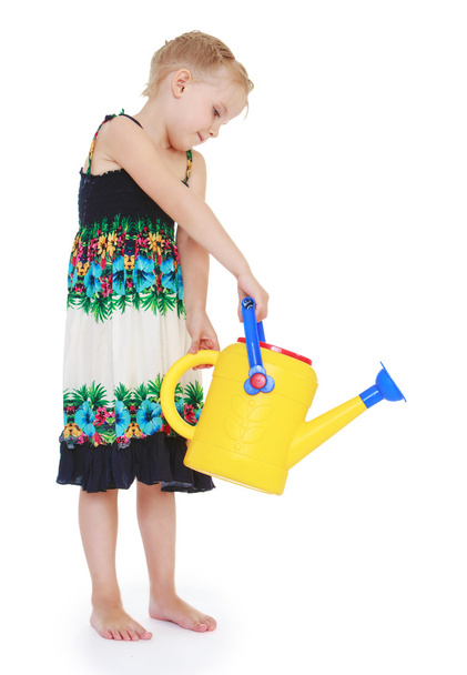little girl in summer silk long dress from garden watering water - Фото, зображення