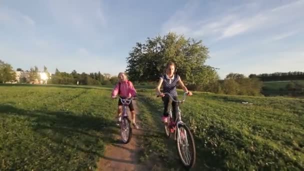 Girls riding bicycle in the countryside - Footage, Video