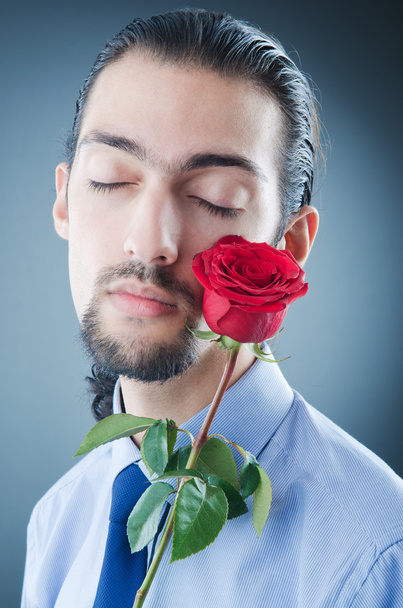 Young man with red rose - Fotoğraf, Görsel