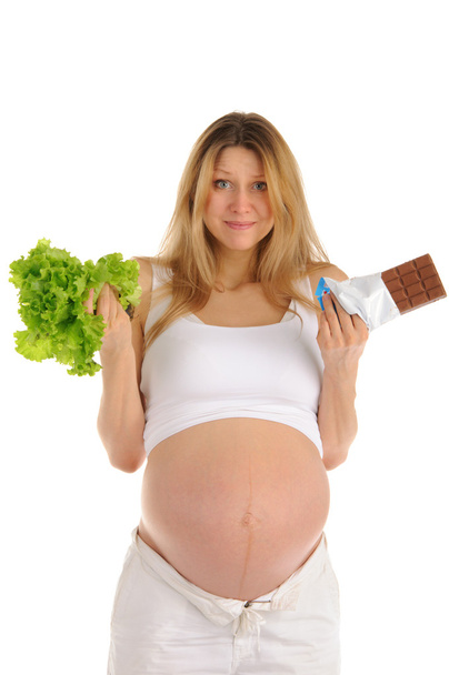 Pregnant woman with chocolate and lettuce - Valokuva, kuva