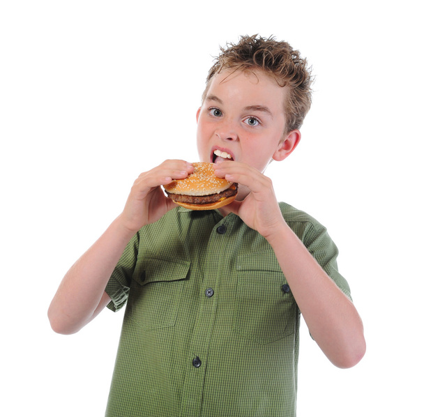 Little boy eating a hamburger - Zdjęcie, obraz