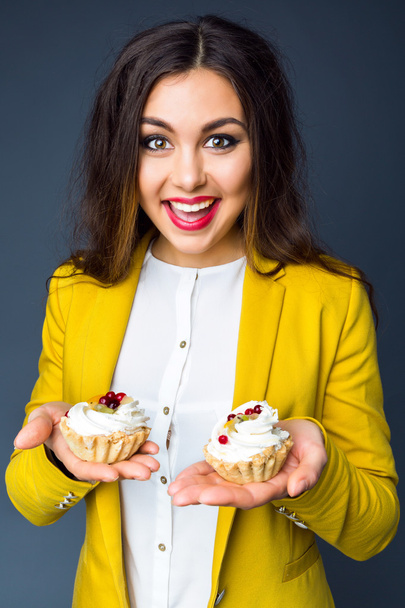 woman holding two tasty cakes - Фото, зображення