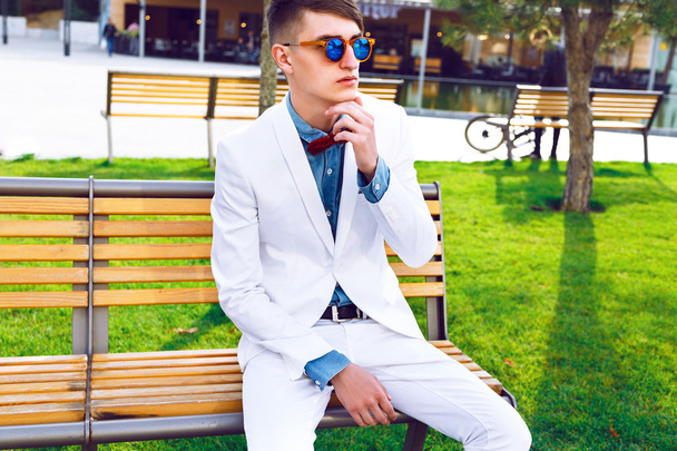 hipster man sitting on the bench - 写真・画像