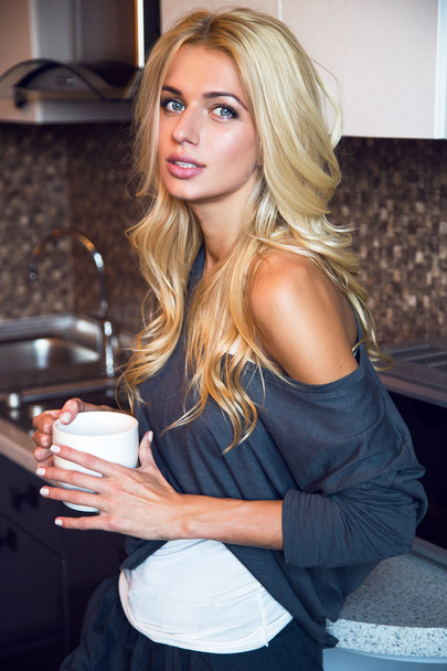 woman drinking coffee at the kitchen - Photo, Image