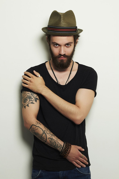 handsome man in hat.Brutal bearded boy with tattoo - Photo, Image