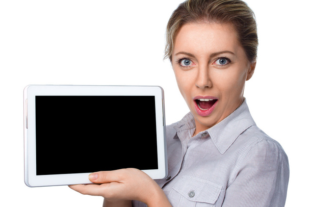 Young cheerful surprised woman is showing blank table - Photo, image