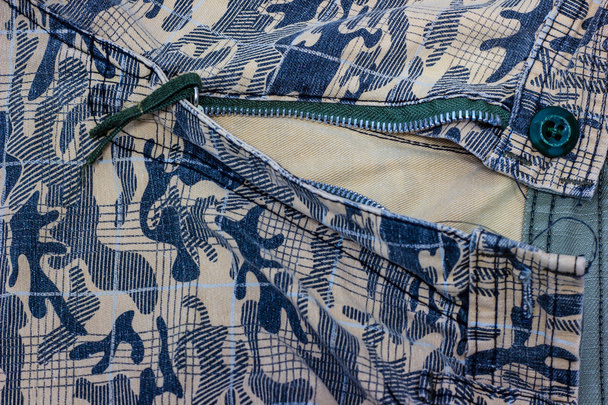 κοντινό πλάνο ύφασμα υφή στρατιωτική καμουφλάζ με ανοιχτό φερμουάρ - Φωτογραφία, εικόνα