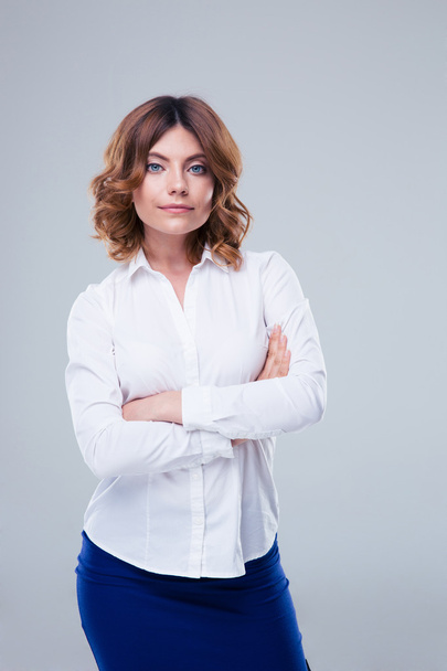Happy businesswoman standing with arms folded  - Fotoğraf, Görsel