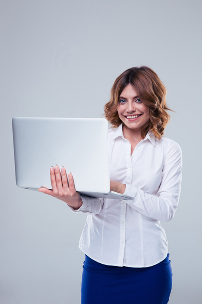 Happy businesswoman using laptop - Fotó, kép