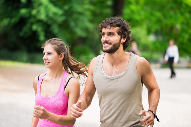 Couple running in a park - Photo, Image