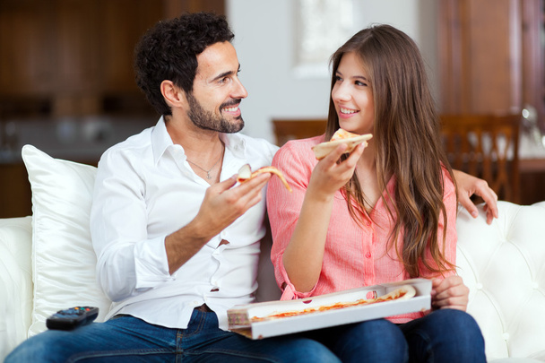 Couple with pizza and TV remote - Foto, Imagem