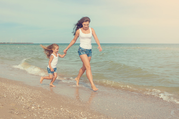 Happy beautiful mother and daughter enjoying beach time  - Photo, Image