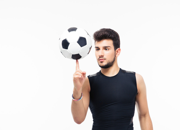 Soccer player spinning ball on his finger - Фото, изображение