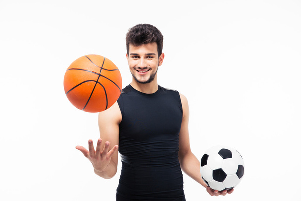 Sports man holding basketball and soccer ball - Foto, imagen