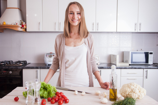 Молода жінка готує на кухні
 - Фото, зображення