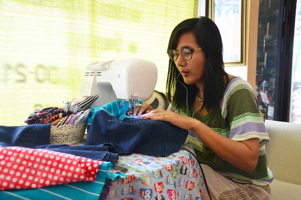 Asian women use machine sewing clothes - Photo, Image