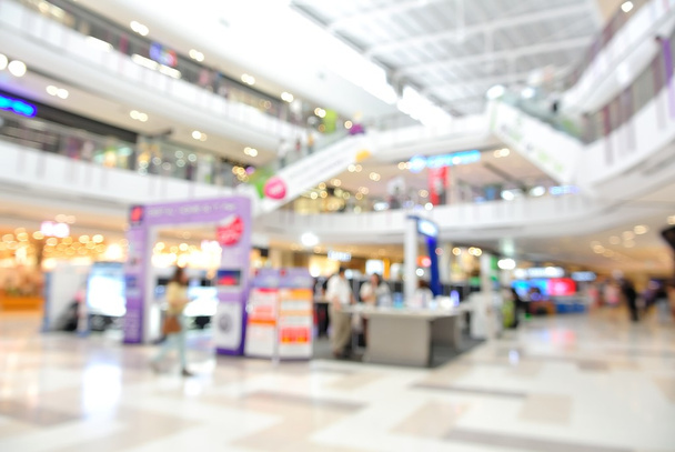 Размытый фон с Bokeh людей, совершающих покупки в mall in the
  - Фото, изображение