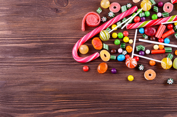 Colorful candies on wooden background - 写真・画像