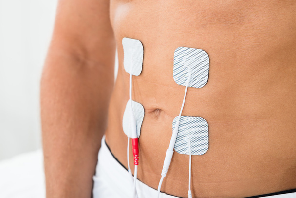 Man With Electrodes On Stomach - Foto, afbeelding