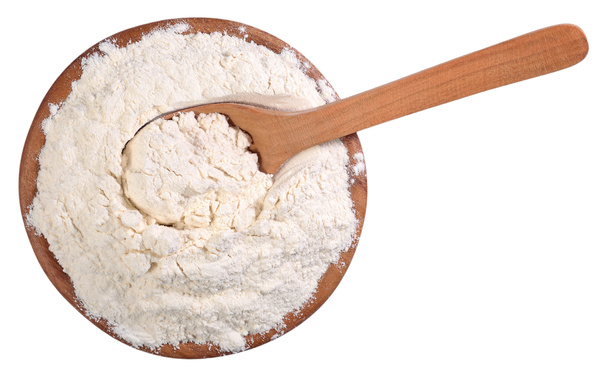 Top view of white flour in a wooden bowl with spoon on a white - Photo, Image