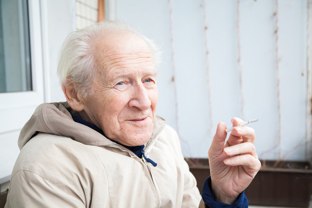 smiling old man with a cigarette - Photo, image
